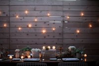 Hang lights on your fence to create a gorgeous dining area.