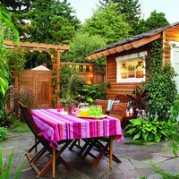 Use a pretty fence and arbor to define the boundaries of your outdoor room.